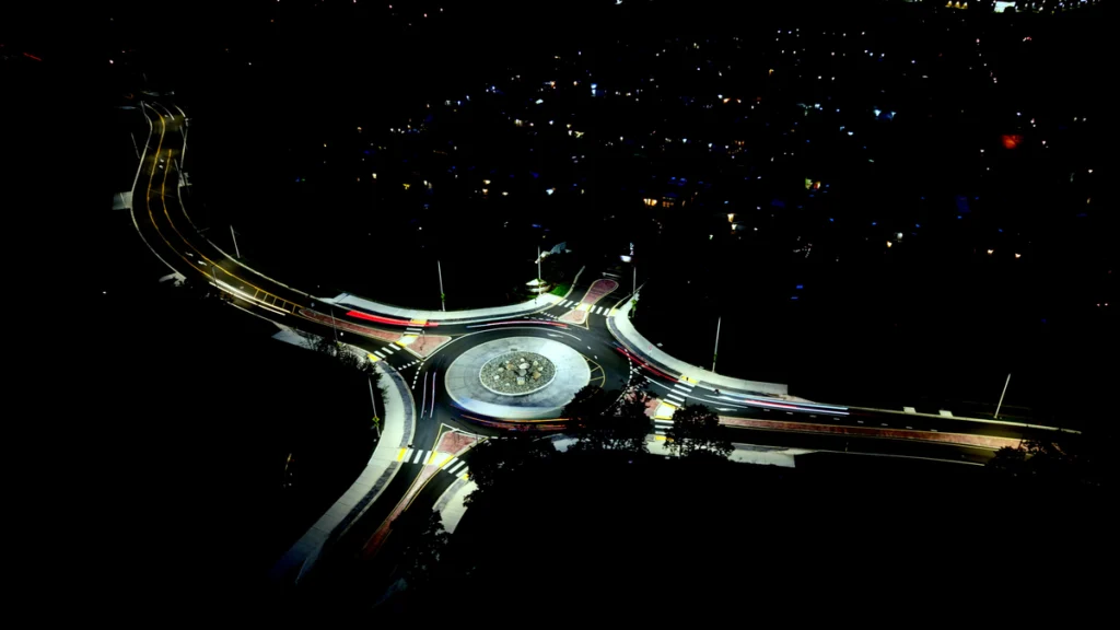 Night drone hyperlapse — car light streaks circling a roundabout, shot with a DJI Air 3S.
